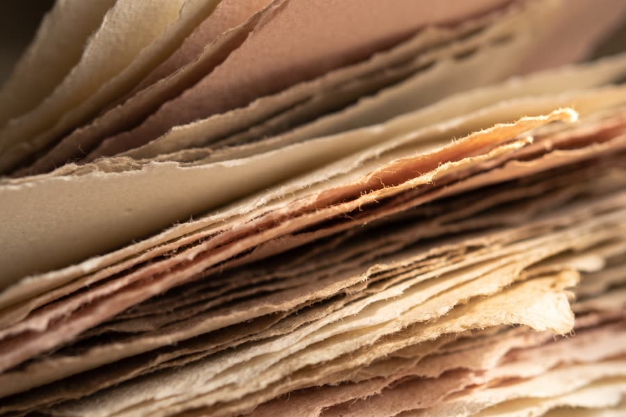 Overlapping ivory and blush paper stocks